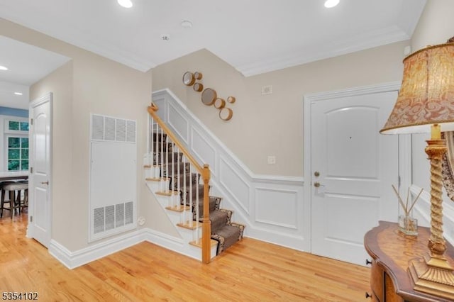 foyer featuring stairs, recessed lighting, a heating unit, and light wood-style floors
