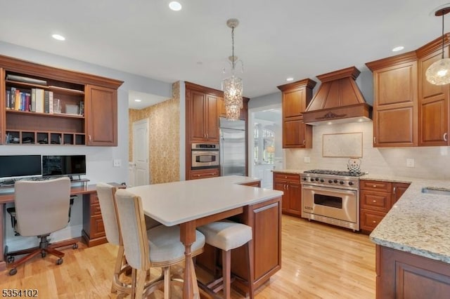 kitchen featuring backsplash, high quality appliances, custom exhaust hood, and light wood-style flooring