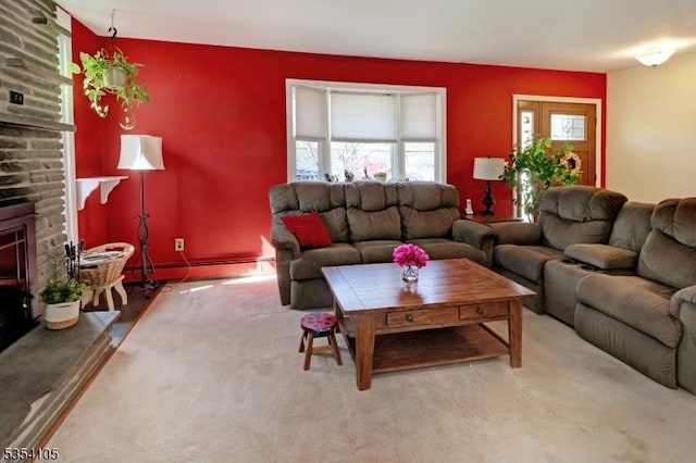 carpeted living room with a baseboard heating unit and a large fireplace