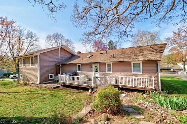 rear view of property featuring a lawn, a deck, and a chimney