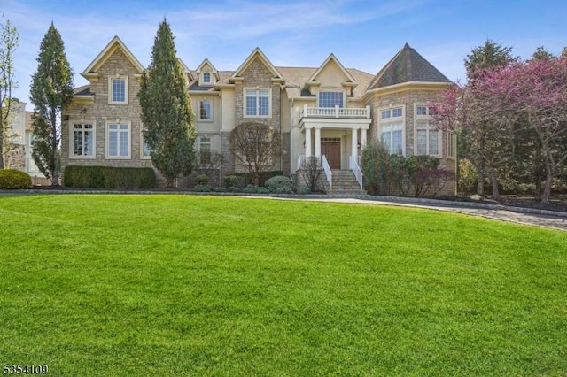 view of front of home featuring a front yard and stone siding