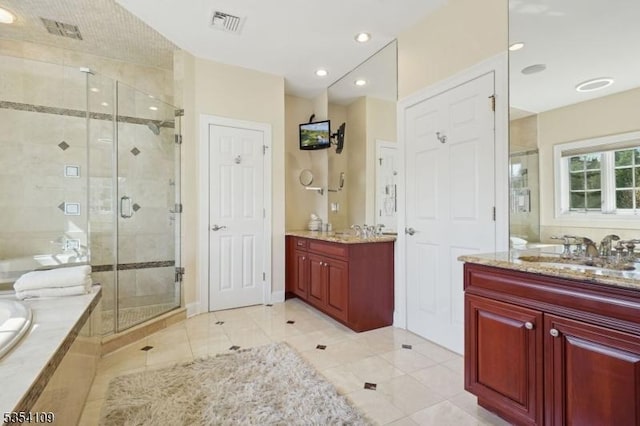 full bathroom featuring a garden tub, a sink, tile patterned flooring, and a shower stall