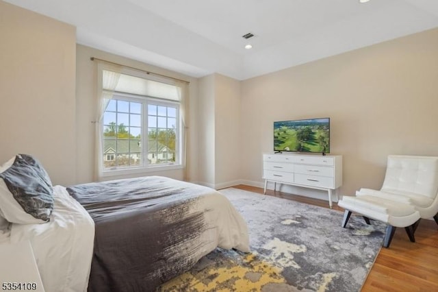bedroom with visible vents, recessed lighting, baseboards, and wood finished floors