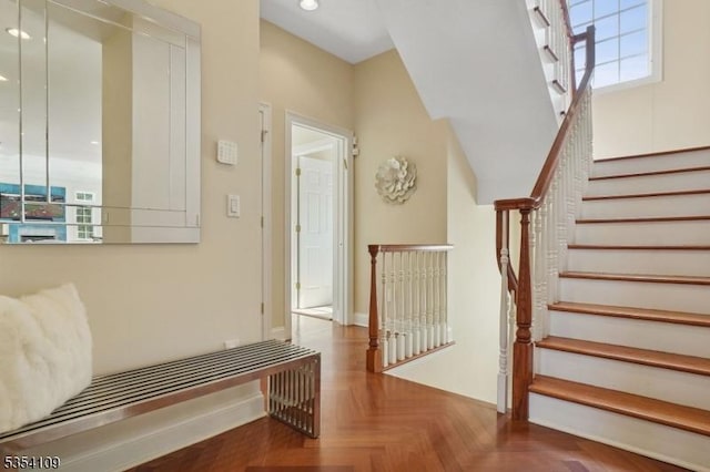 stairway with baseboards and recessed lighting