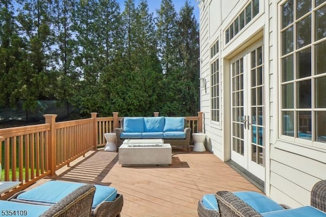 wooden terrace with french doors and outdoor lounge area