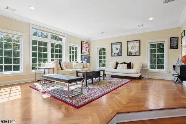 living room with baseboards, crown molding, and visible vents