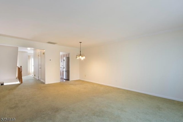 empty room featuring baseboards, visible vents, light carpet, and a chandelier