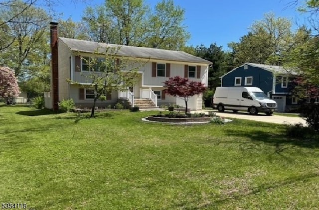 61 Duval St, Bridgewater Twp, NJ 08807 - bi-level home featuring driveway, a front yard, and a chimney