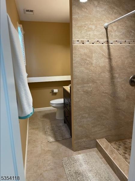 61 Duval St, Bridgewater Twp, NJ 08807 - full bath featuring a tile shower, tile patterned flooring, vanity, toilet, and visible vents