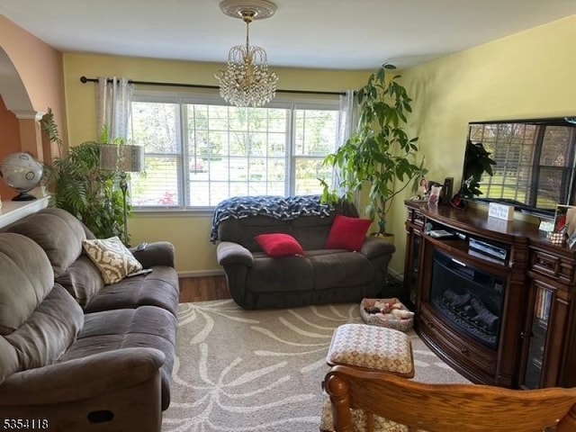 61 Duval St, Bridgewater Twp, NJ 08807 - living room with a healthy amount of sunlight, arched walkways, an inviting chandelier, and wood finished floors