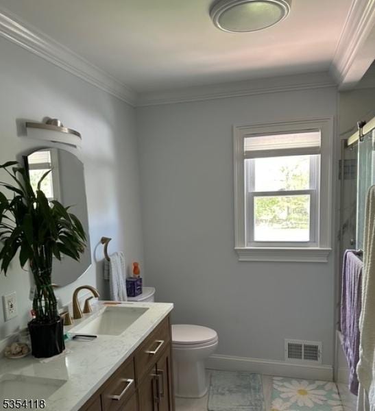 61 Duval St, Bridgewater Twp, NJ 08807 - bathroom featuring visible vents, double vanity, toilet, baseboards, and a sink