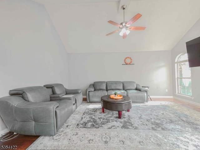 living area featuring baseboards, a ceiling fan, and lofted ceiling