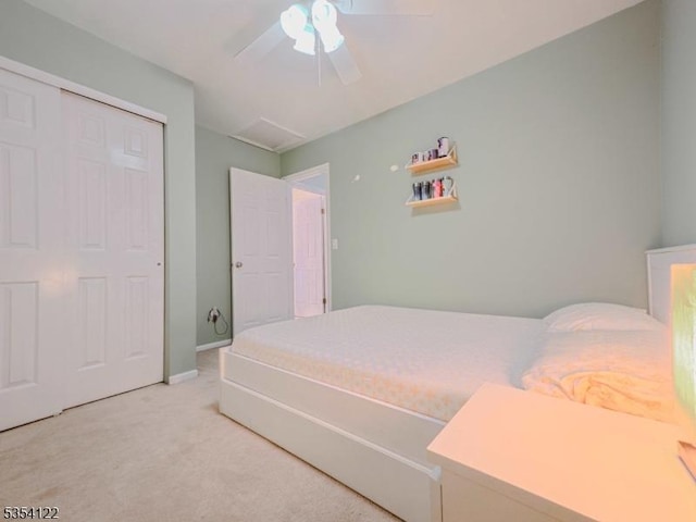 bedroom with a closet, a ceiling fan, carpet, and baseboards