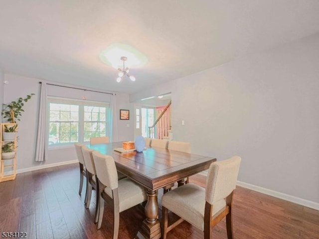 dining space featuring plenty of natural light, a chandelier, and dark wood-style floors