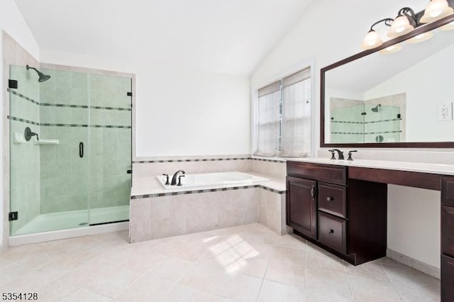 bathroom featuring vanity, tile patterned floors, vaulted ceiling, a bath, and a stall shower