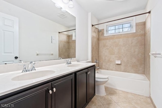 full bath with double vanity, toilet, a sink, and tile patterned flooring