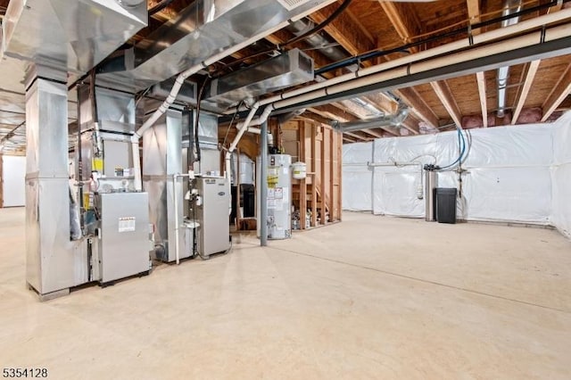 unfinished below grade area featuring heating unit and water heater