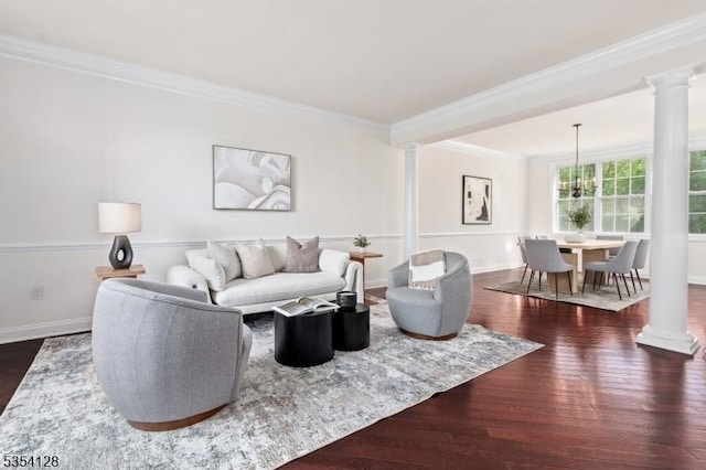 living area with baseboards, ornamental molding, decorative columns, and dark wood finished floors