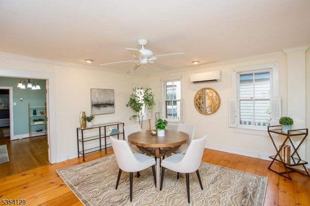 dining space featuring crown molding, a wall mounted AC, ceiling fan with notable chandelier, and hardwood / wood-style floors