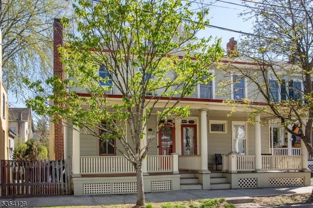 view of front of house featuring a porch and a chimney