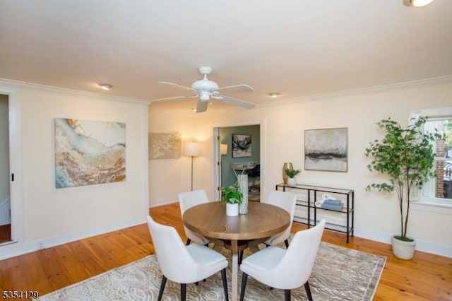 dining area featuring baseboards, ornamental molding, hardwood / wood-style flooring, and ceiling fan