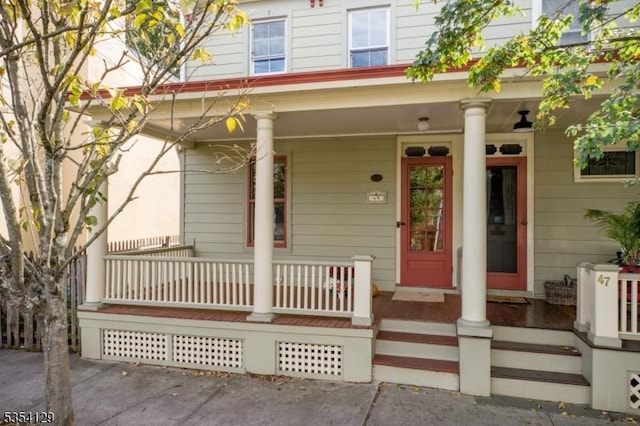view of exterior entry with a porch