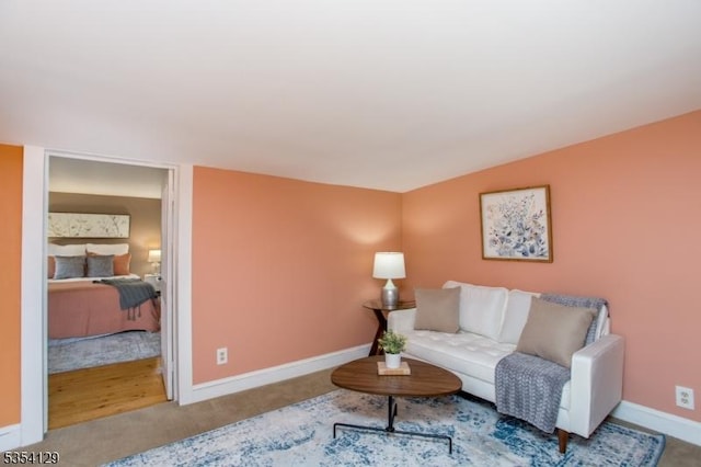 carpeted living room featuring baseboards
