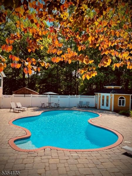 view of pool featuring a fenced in pool, a fenced backyard, and a patio area