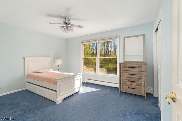 bedroom with dark carpet, a baseboard radiator, and ceiling fan