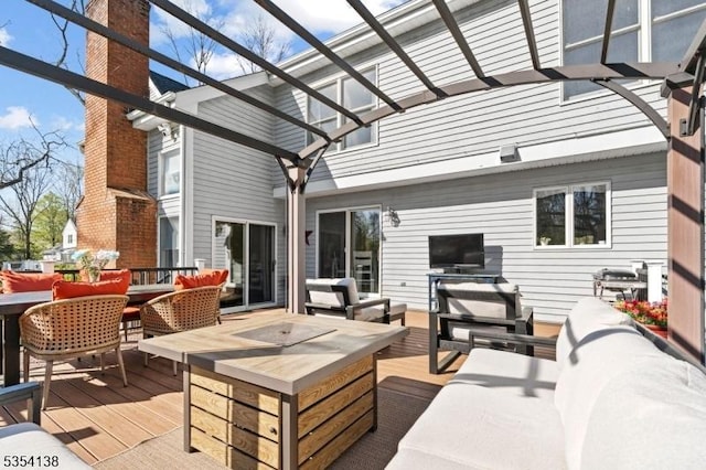 wooden deck with outdoor dining space, a pergola, and outdoor lounge area