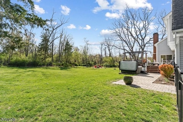 view of yard featuring a deck and a patio