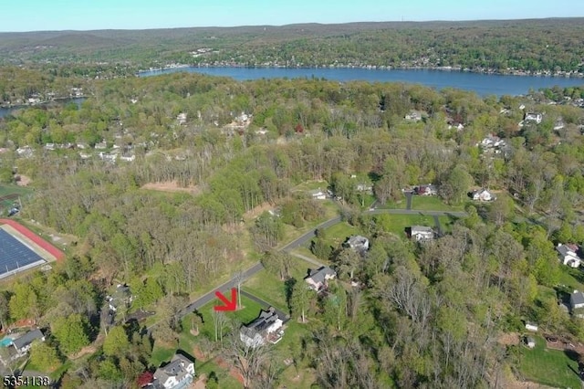 bird's eye view featuring a forest view and a water view