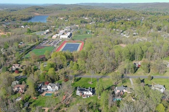 bird's eye view with a water view and a view of trees
