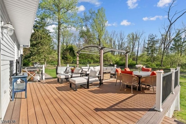 wooden terrace featuring outdoor dining area, a pergola, and an outdoor hangout area