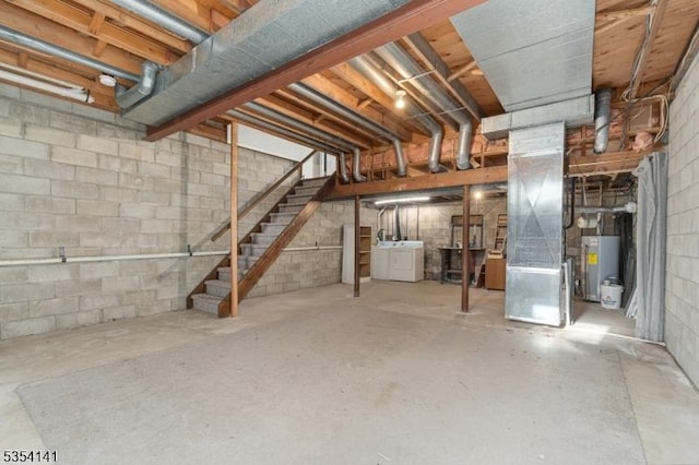 unfinished below grade area with stairs, heating unit, washer / clothes dryer, water heater, and concrete block wall