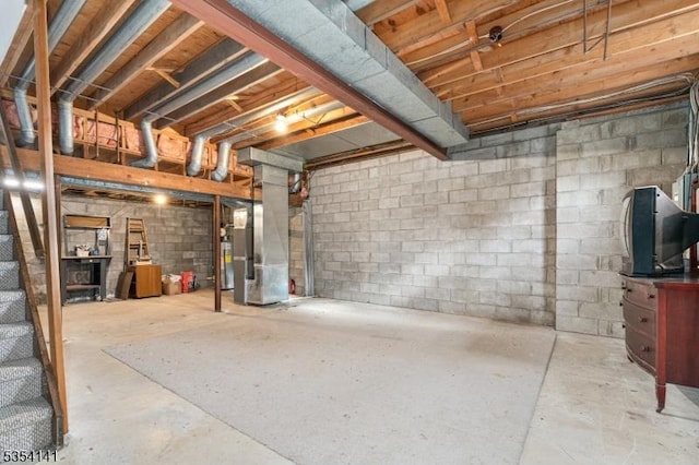 unfinished basement featuring heating unit and water heater