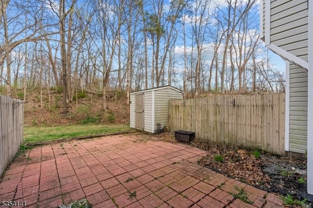 view of patio / terrace with fence, a storage unit, and an outdoor structure