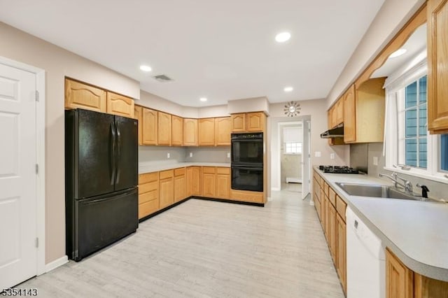 12 Toth Ct, Clifton City, NJ 07014 - kitchen featuring light brown cabinetry, baseboards, under cabinet range hood, a sink, and black appliances