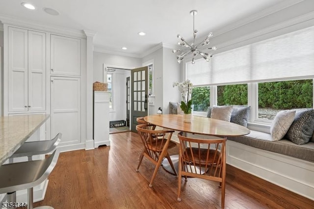 dining room with recessed lighting, an inviting chandelier, ornamental molding, and dark wood-type flooring