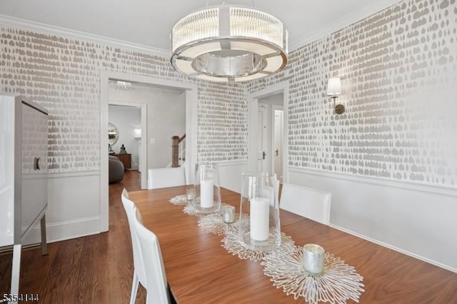 dining space with crown molding, wallpapered walls, and wood finished floors