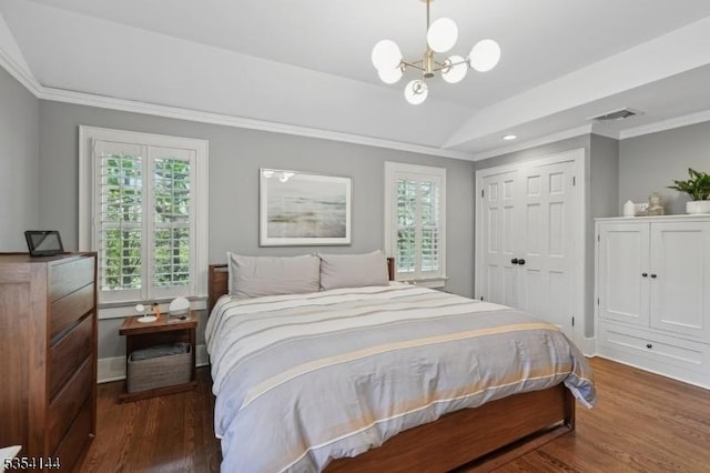 bedroom with visible vents, wood finished floors, a closet, a notable chandelier, and ornamental molding