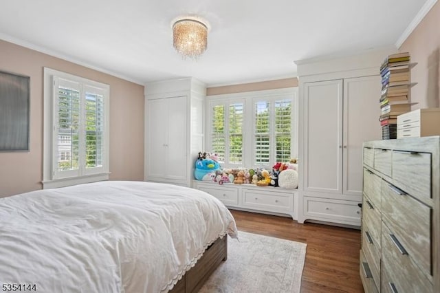 bedroom with dark wood-type flooring and ornamental molding