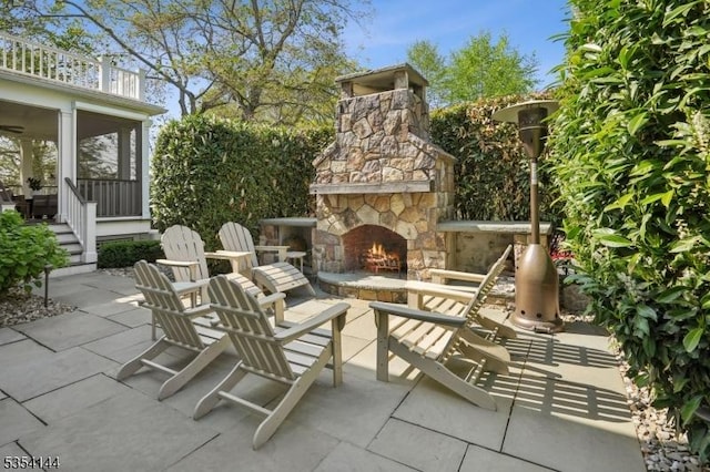 view of patio with an outdoor stone fireplace