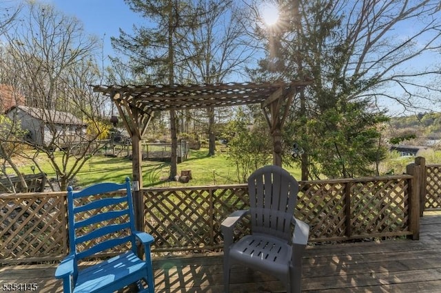 wooden deck with a yard and a pergola