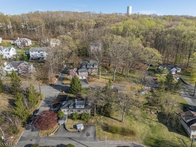 aerial view featuring a residential view and a wooded view