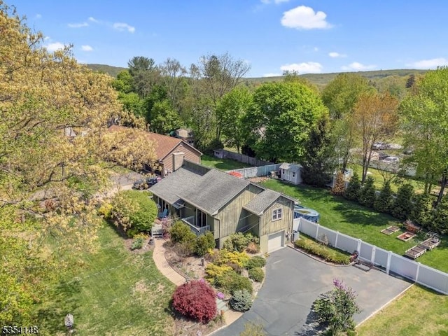 drone / aerial view featuring a wooded view