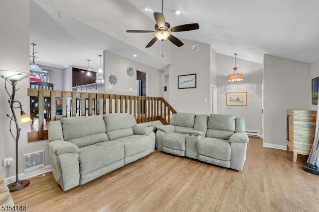 living area with visible vents, a ceiling fan, baseboards, and wood finished floors