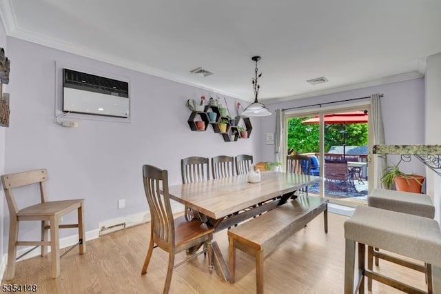 dining area with crown molding, light wood finished floors, a wall unit AC, and visible vents