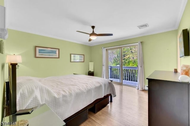 bedroom with ceiling fan, access to exterior, wood finished floors, a baseboard radiator, and visible vents