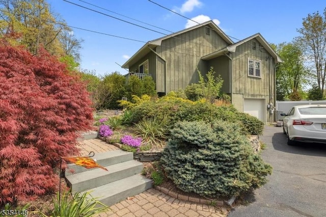 view of home's exterior with a garage and aphalt driveway